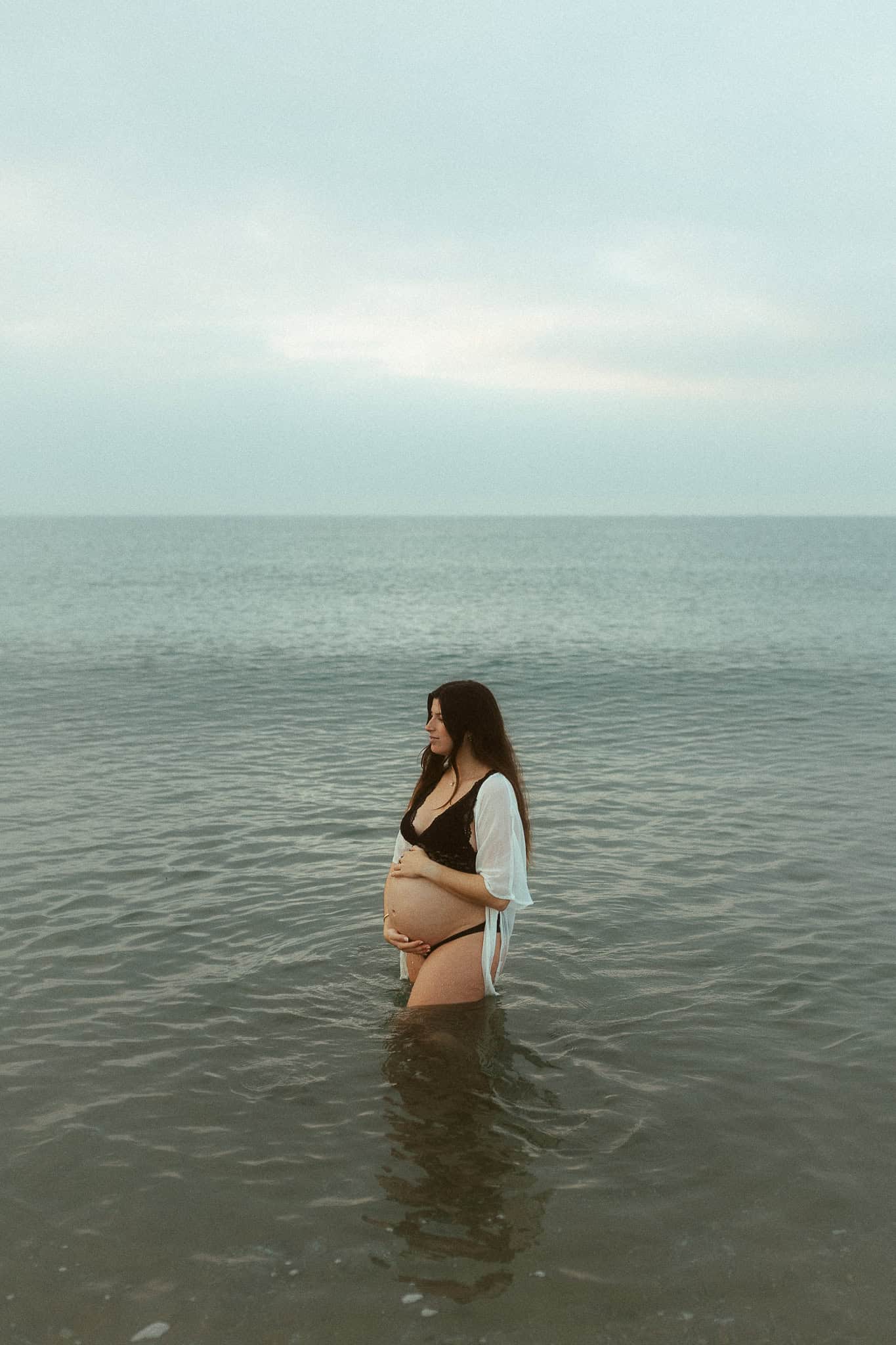 Artistic pregnancy photoshoot in the sea